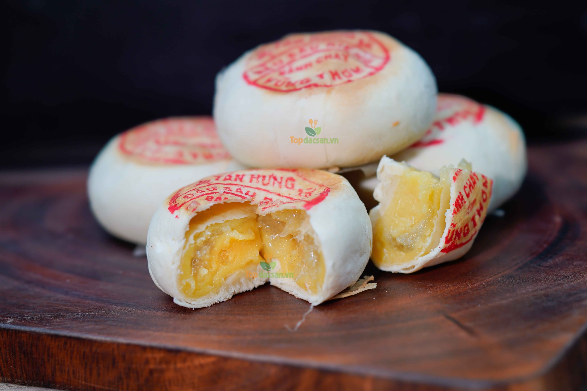 Banh pia is a flaky Vietnamese pastry filled with rich durian, mung bean, and sometimes salted egg yolk, offering a sweet flavor 